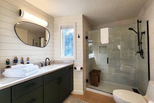 Spa-like walk-in tiled shower and large vanity.