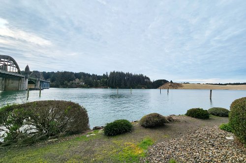 A view of a dune is across the river.