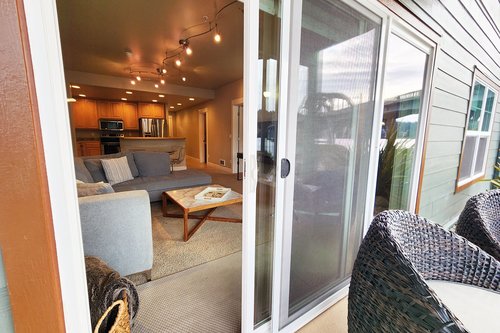 The living room opens to a nice patio to sit and watch the river.