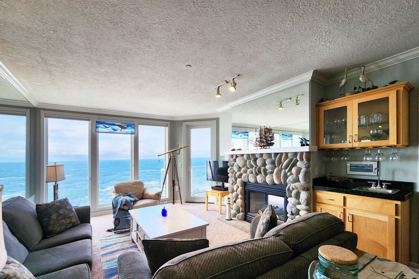 Enjoy a cozy fire and the roaring Pacific from the living room