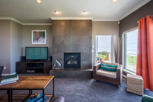 The home has a gas fireplace, and modern furnishings.