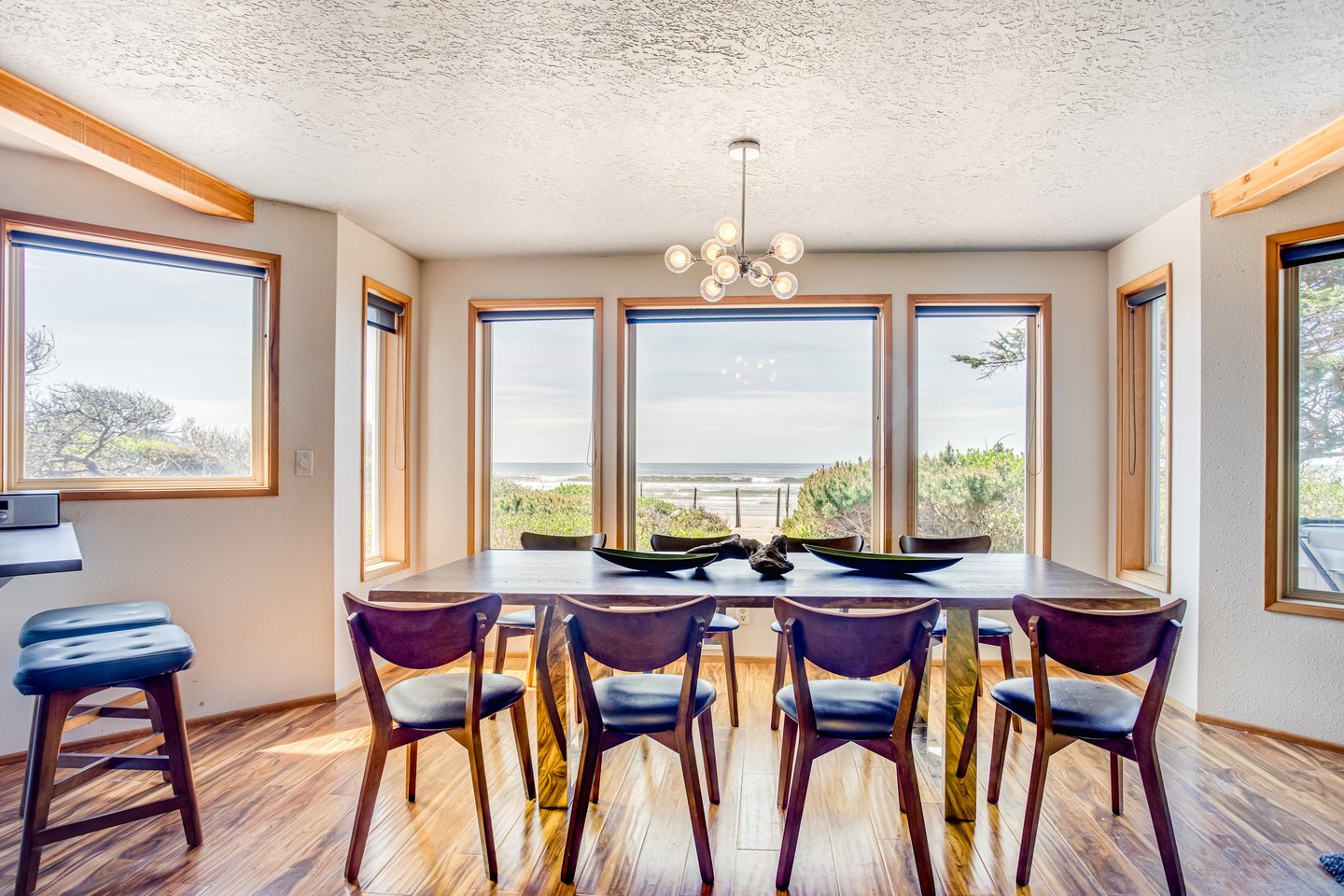 Enjoy the view of the Pacific Ocean as you gather around this large dining table.