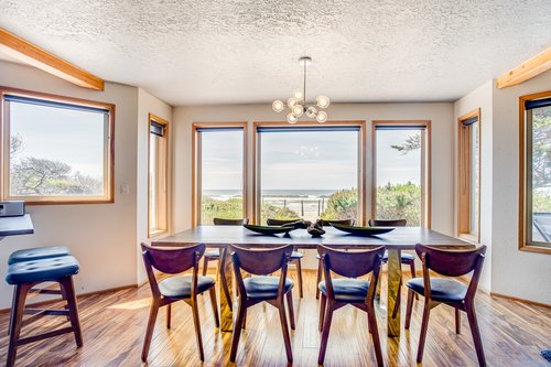 Enjoy the view of the Pacific Ocean as you gather around this large dining table.