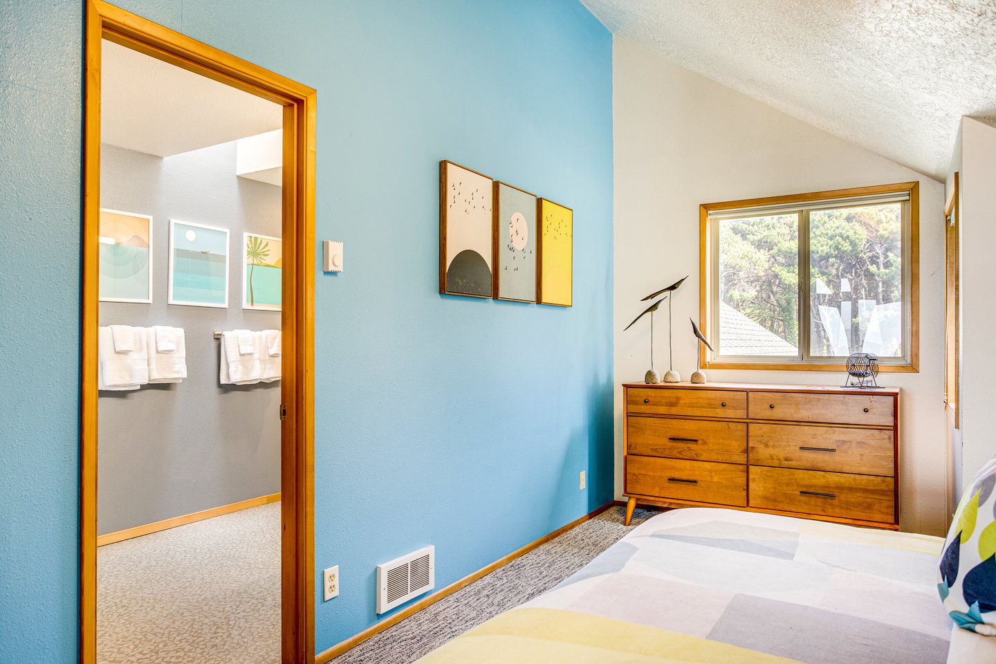 Modern decor and vaulted ceilings in the second upstairs bedroom.