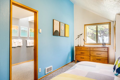 Modern decor and vaulted ceilings in the second upstairs bedroom.