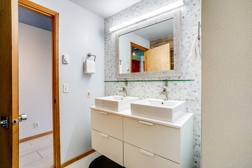 Downstairs bathroom, with custom double vanities.