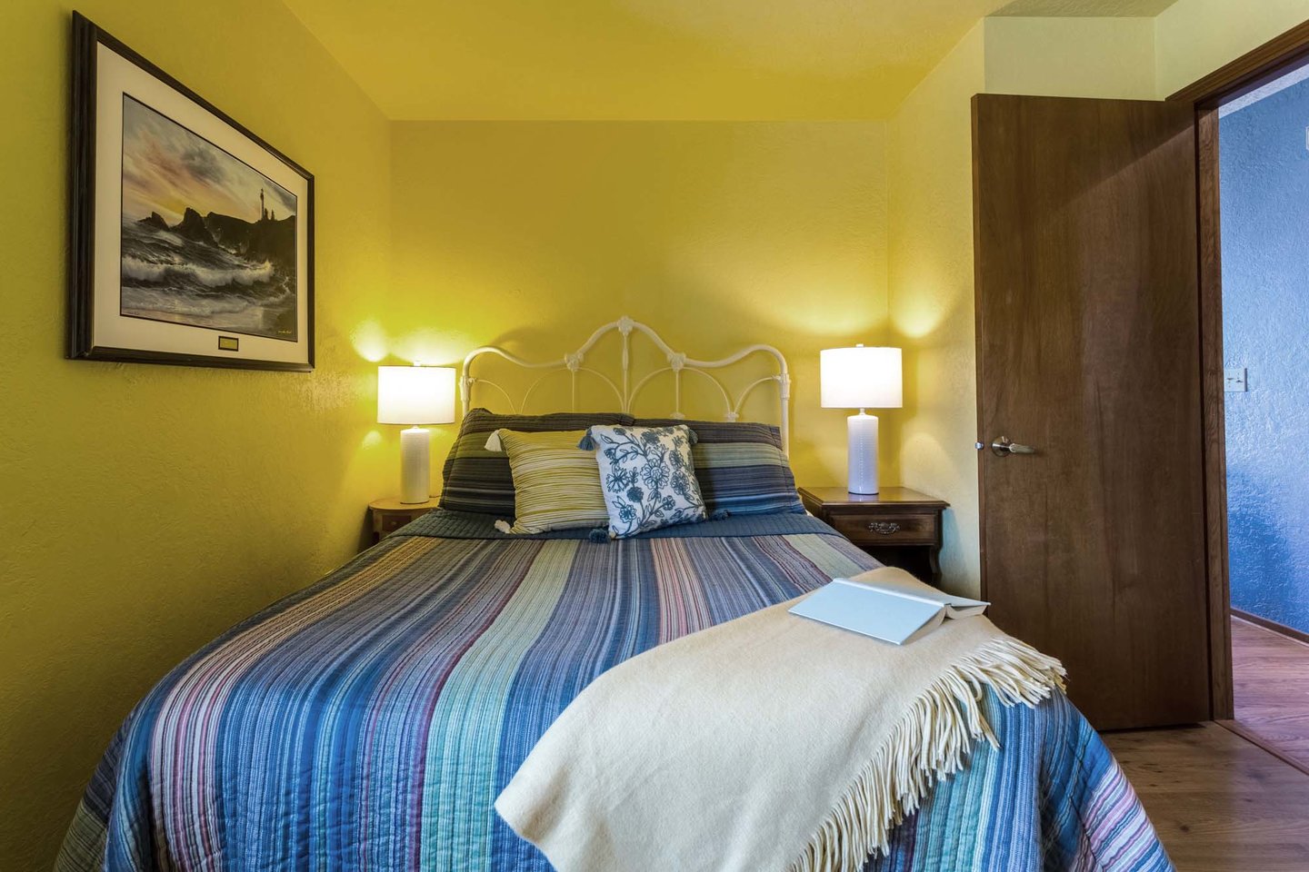 The second bedroom has a cozy queen bed.