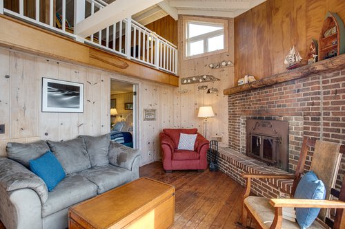 One bedroom off of the living room and one in the loft (the fireplace is non-functional).