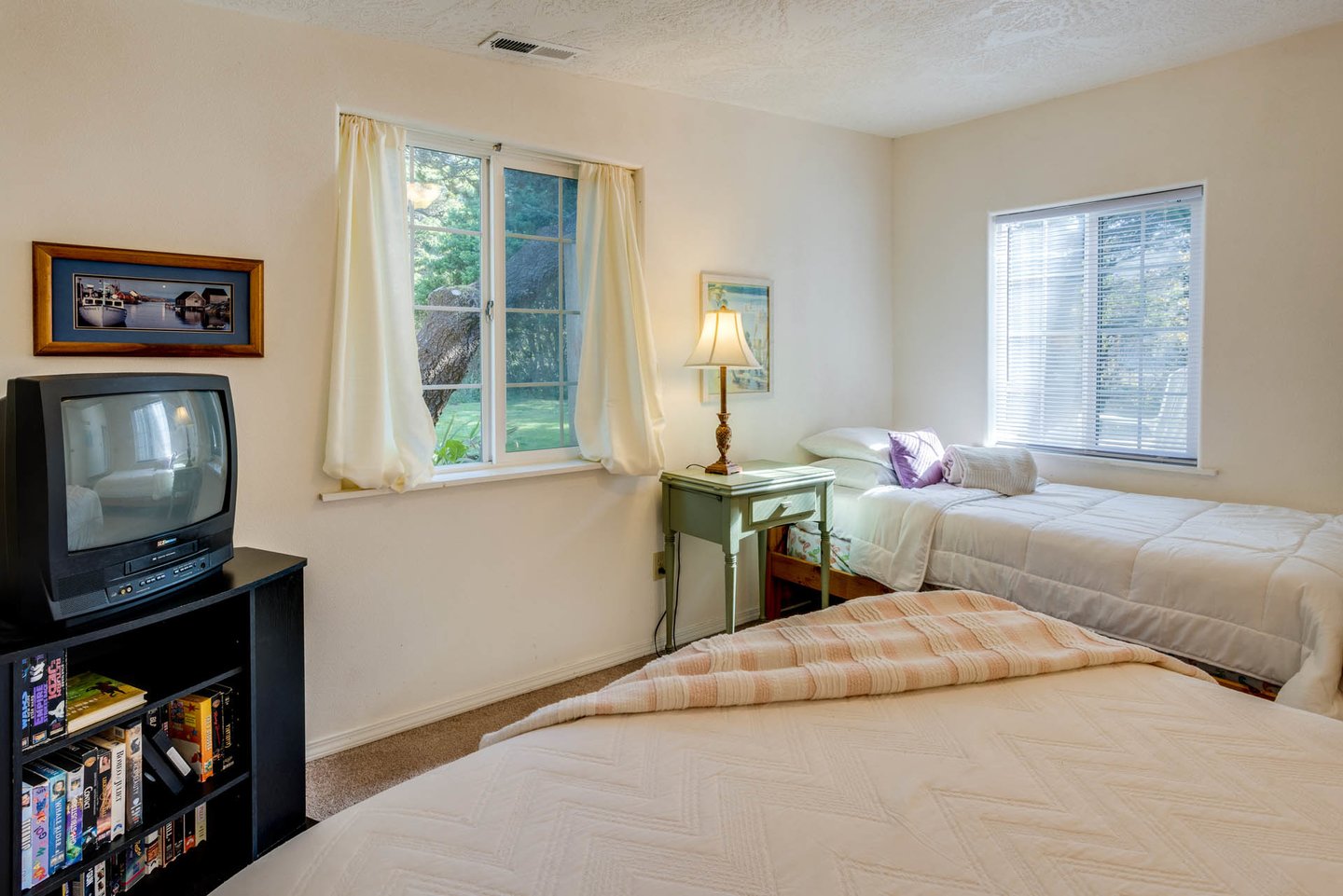 Curl up in the queen bed or twin in this first floor bedroom for a late night movie