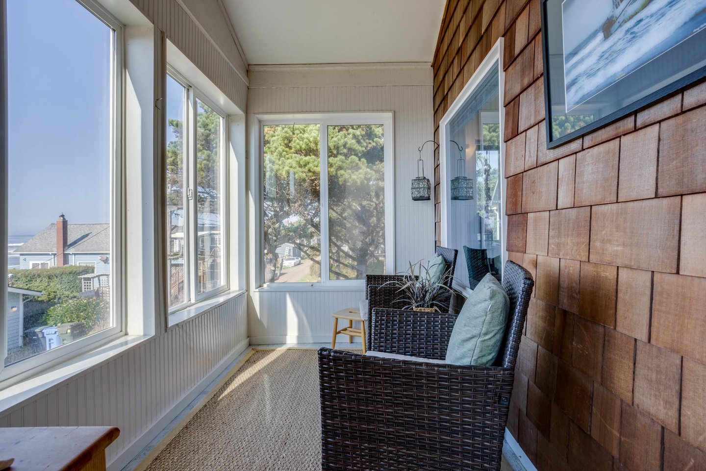 An enclosed sun-room looking out to the Pacific is directly off of the primary suite.