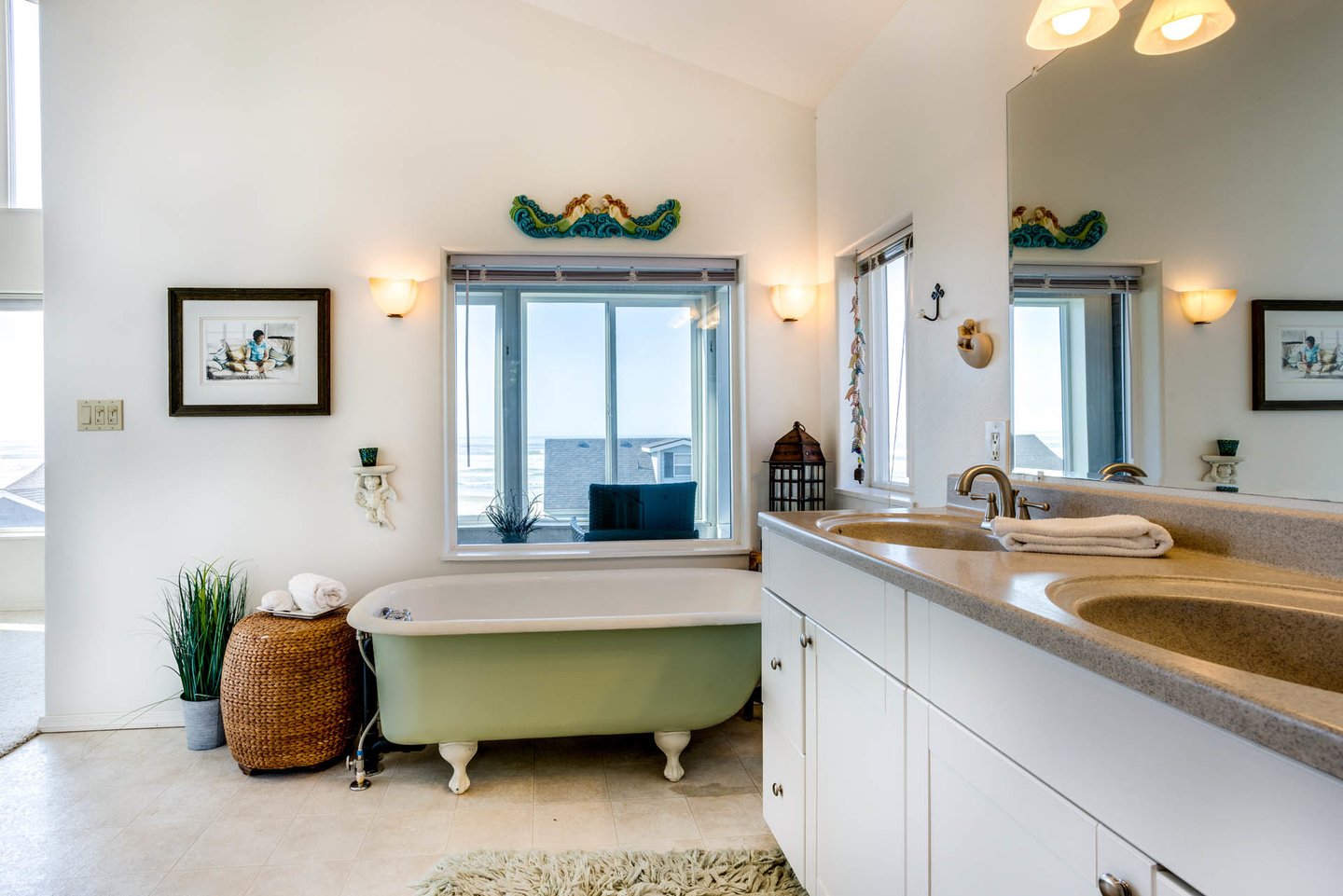 The ensuite primary bathroom has double sink vanity, a clawfoot tub, and shower.