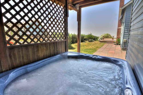 Relax in the hot tub after spending the day beachcombing.