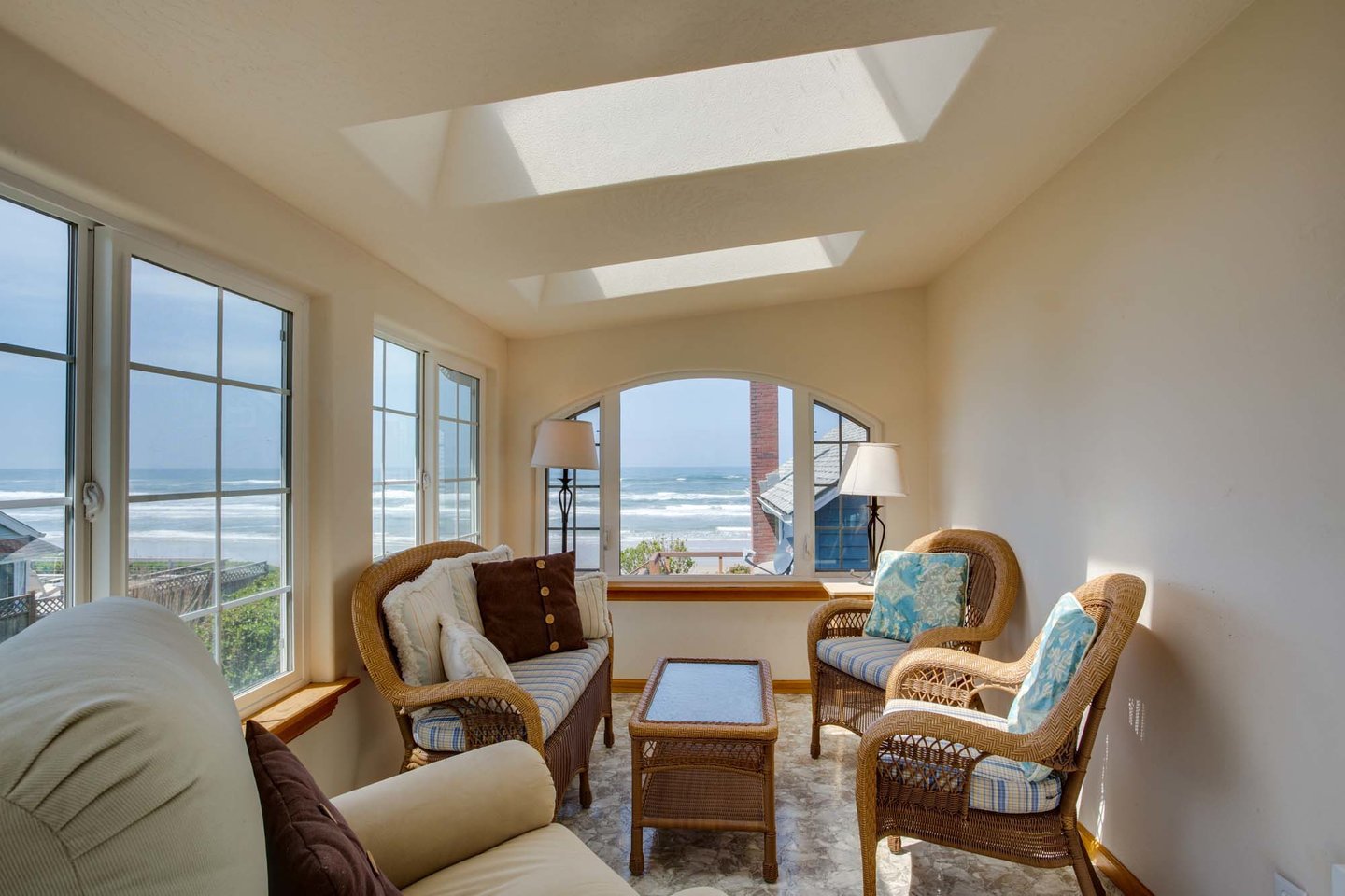 Sunny and bright sitting room off of the apartment is great for relaxing and watching the waves.