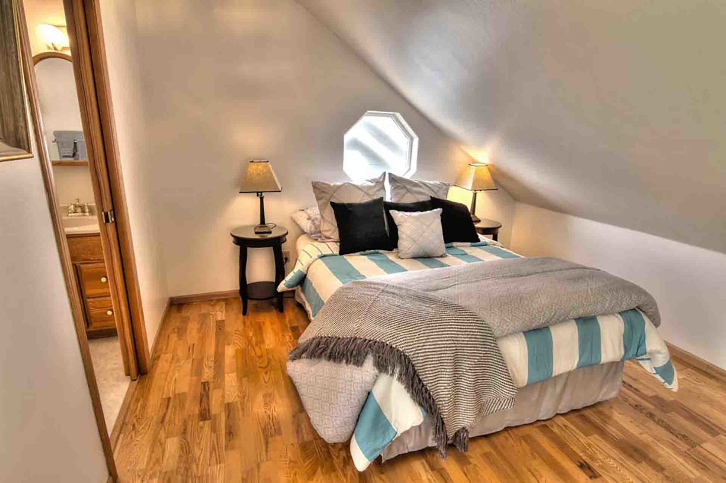 Cozy queen bed is tucked into the apartment.