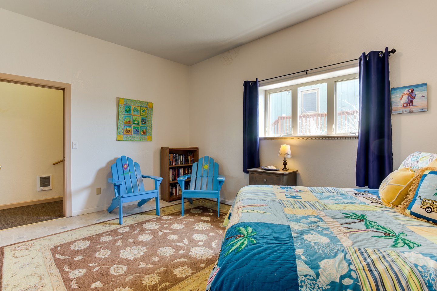 Spacious bedroom with additional seating to relax in.