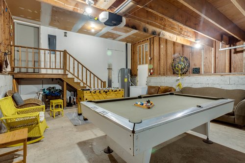 Game room in garage with fooseball and pool table.
