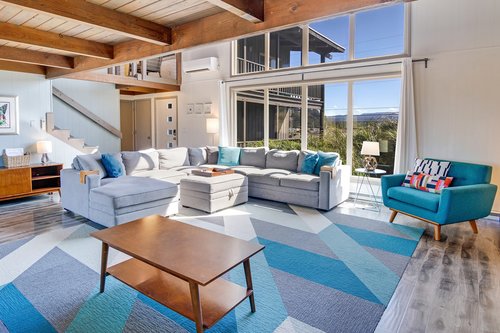 Floor to ceiling windows for a light and airy living room.