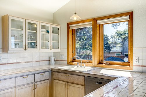 Sunlight pours into the clean kitchen
