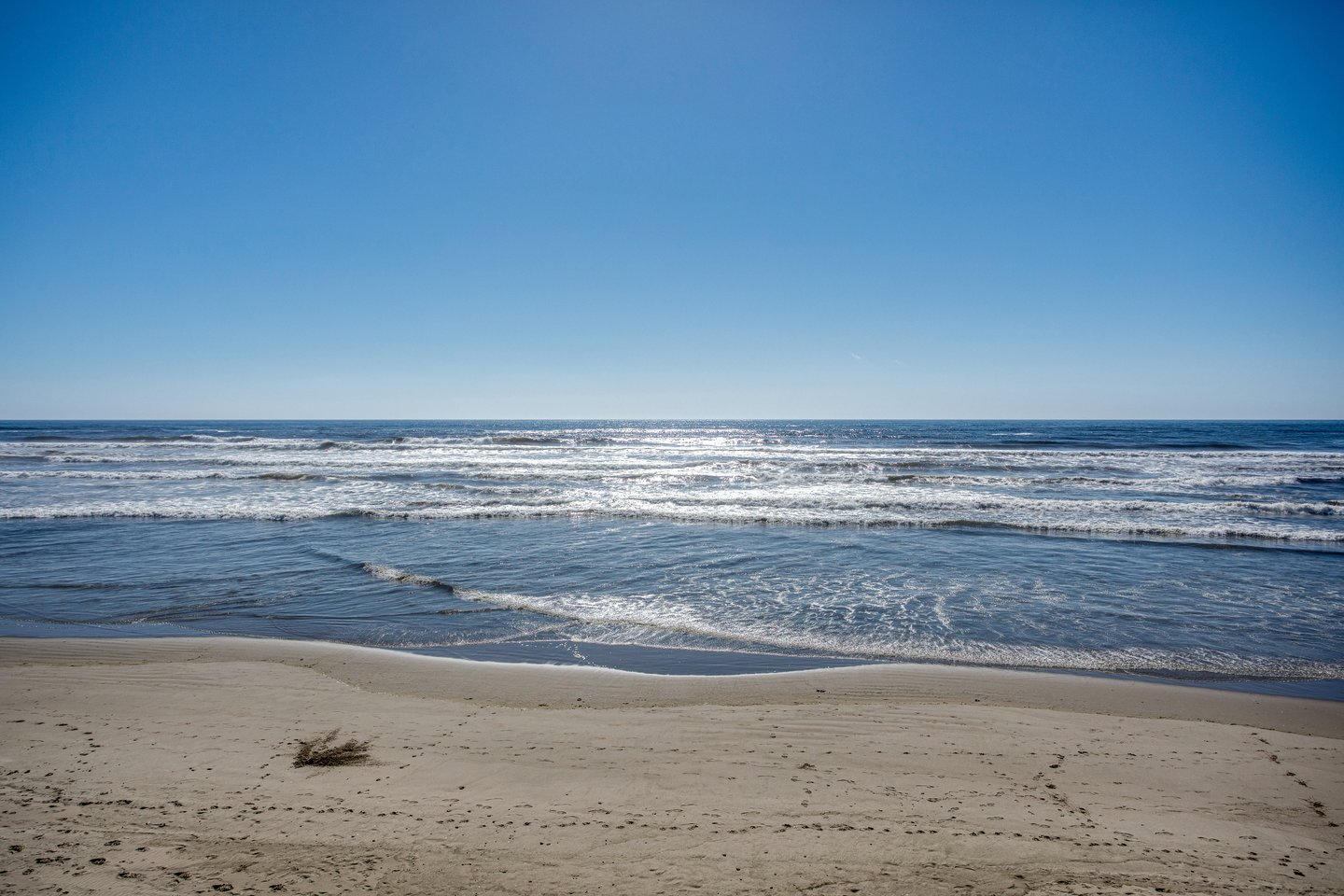 Enjoy the waves and the sunsets from this ocean front home.