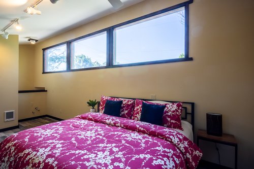 Detached loft  second bedroom above garage features a king bed