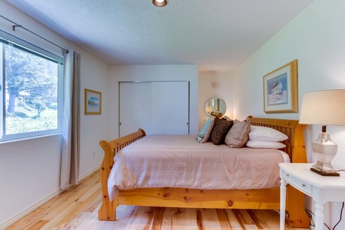 Elegant furnishings, immaculate linens and custom flooring in another king bedroom upstairs.