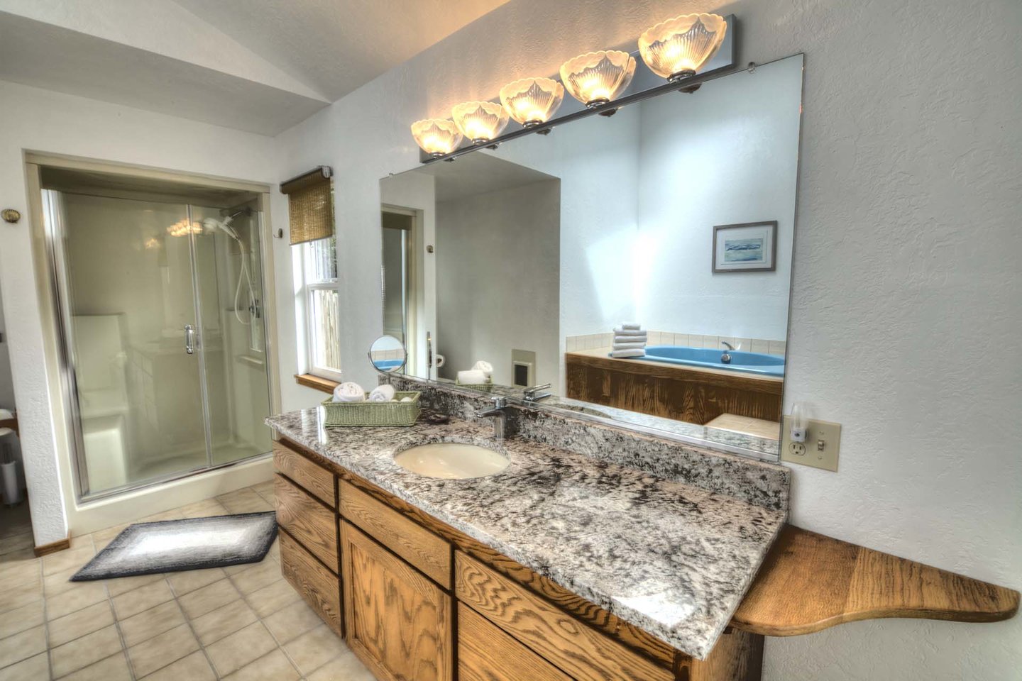 Bright and elegant bath with walk-in shower.