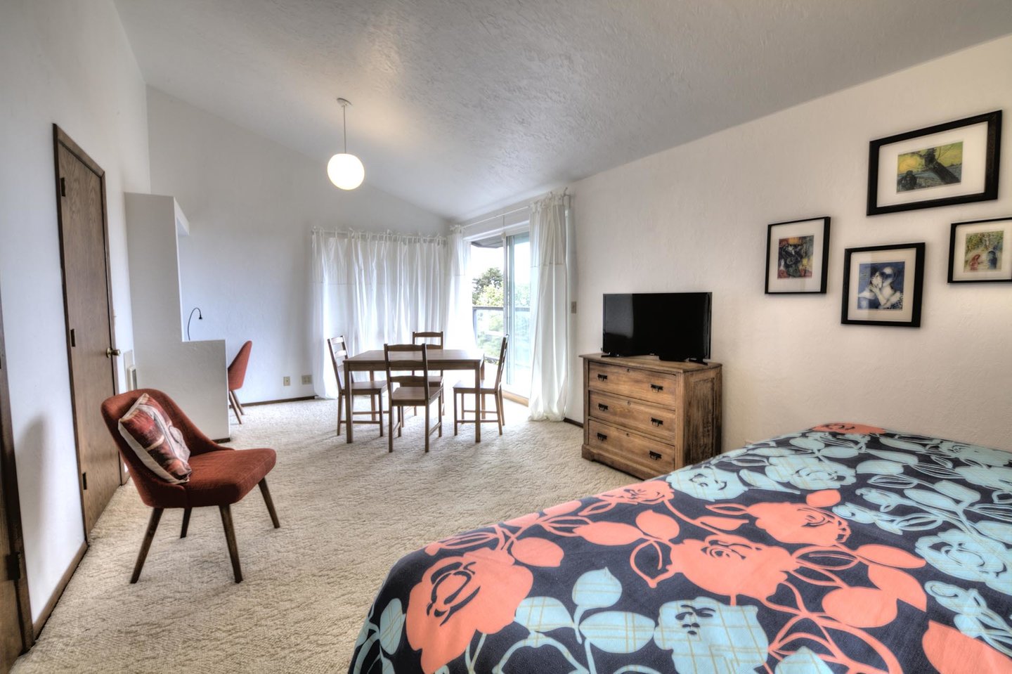 The stylish bedroom provides HDTV,  a sitting area and  deck access.
