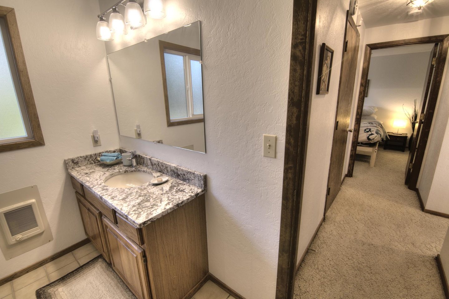Stone countered bath, clean and modern.