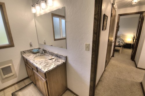 Stone countered bath, clean and modern.