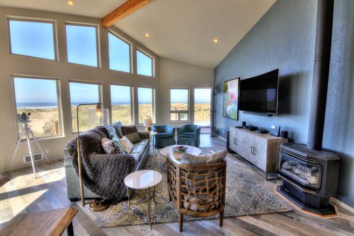 Custom flooring, a gas fireplace and view-friendly architecture welcome all in the great room.