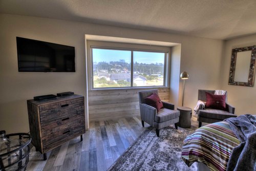 Distinctive comfortable furnishings and bedding, HD TV, and a scenic view.