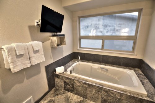 A very private soaking tub in the primary bath with HD TV.