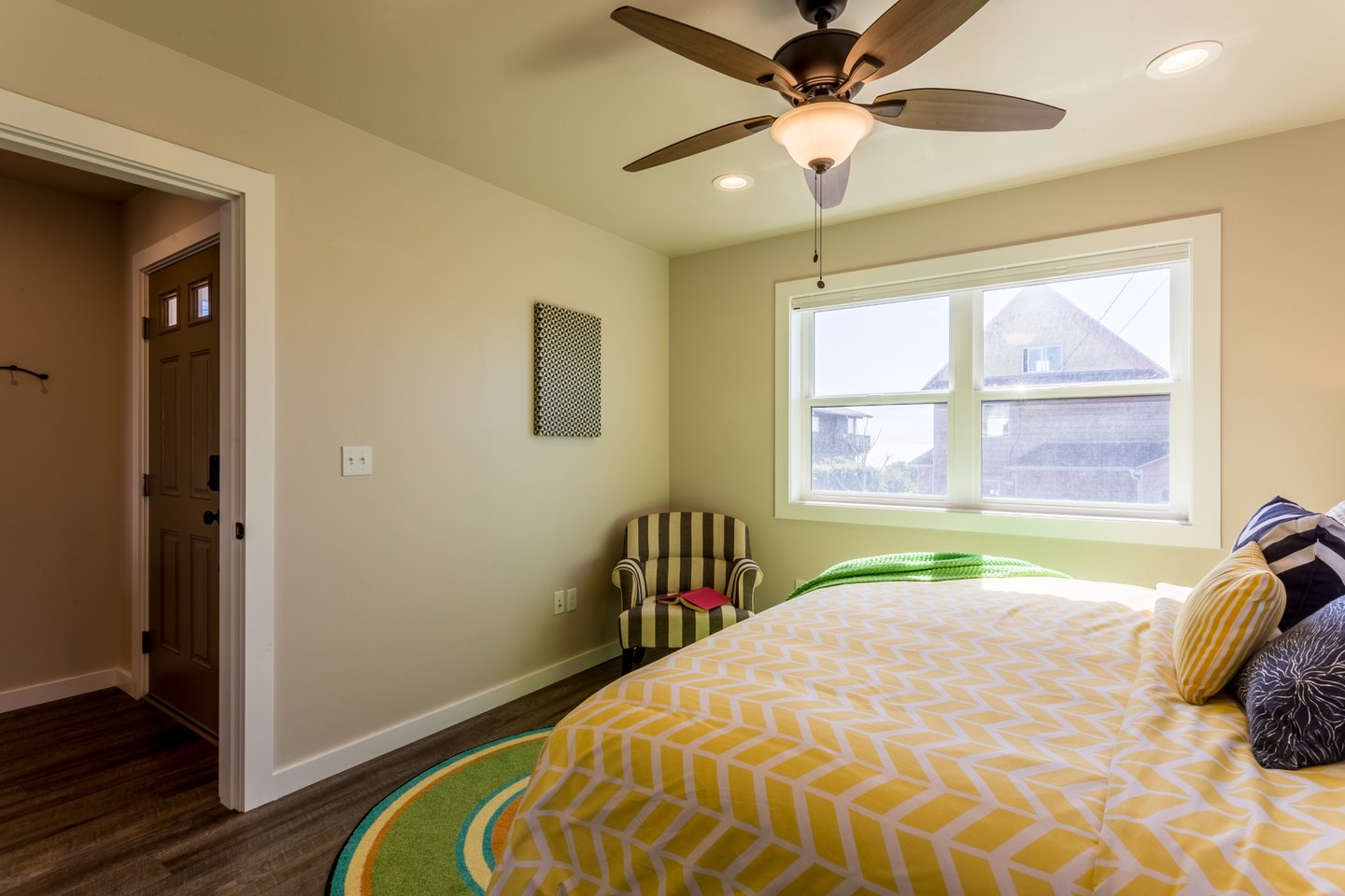 Sunlight pours into the bright bedroom.