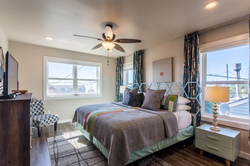 This cool comfy bedroom upstairs features a King bed, ceiling fan, and ensuite bath.