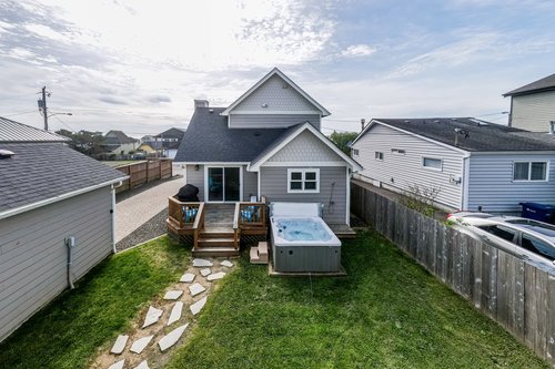 The hot tub waits right off the deck in the back yard.