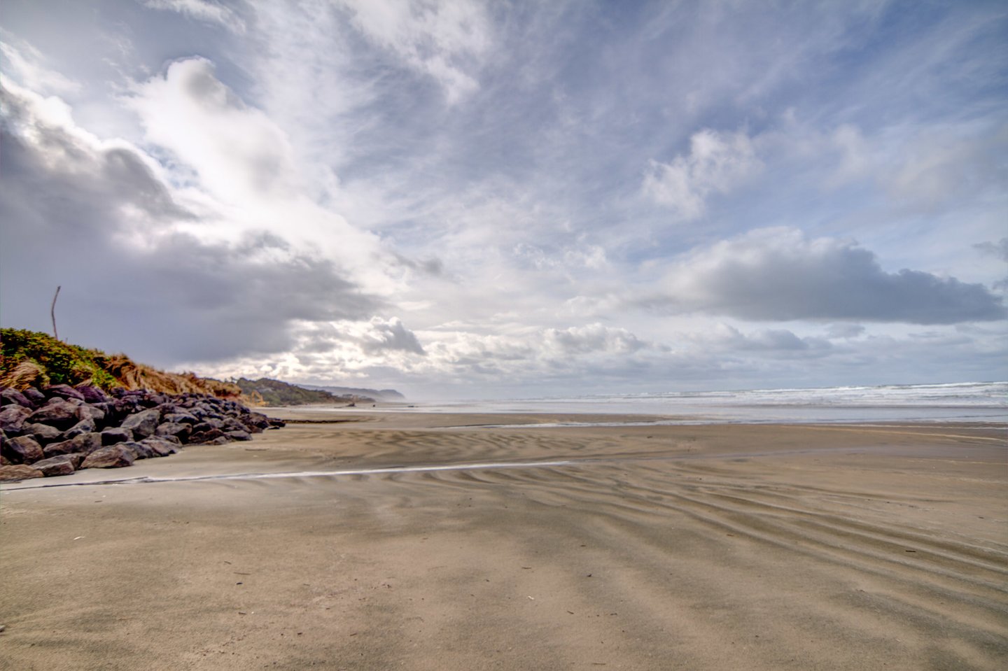 Coastal breezes create magnificent cloud formations as well as transform the sandy beach into wonderous and unique designs.