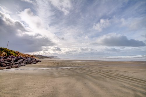 Coastal breezes create magnificent cloud formations as well as transform the sandy beach into wonderous and unique designs.