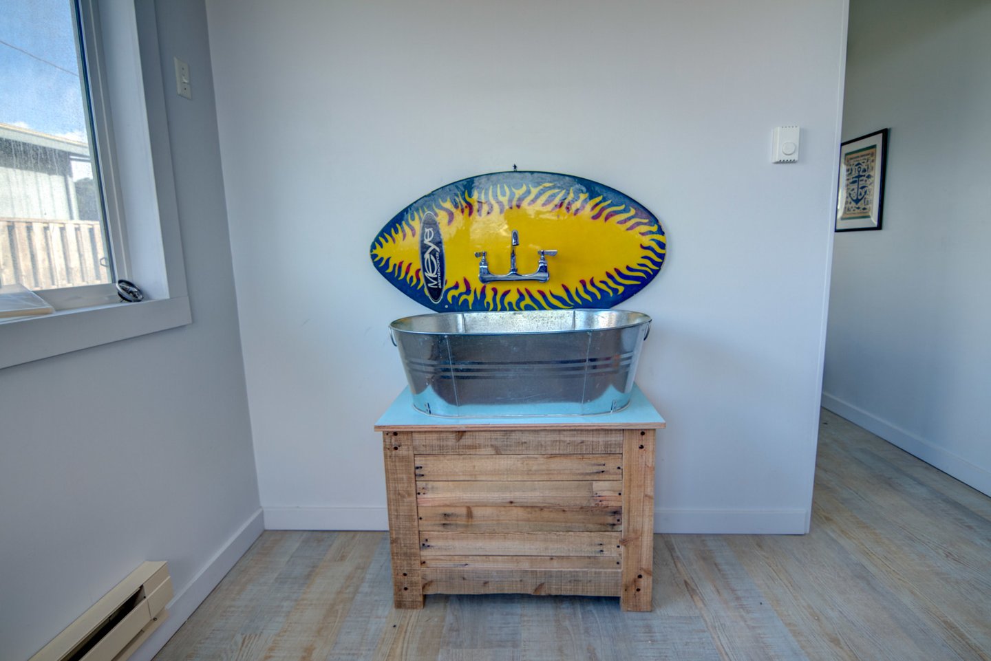 Mud room sink is sporting a skinboard for a different kind of splash.