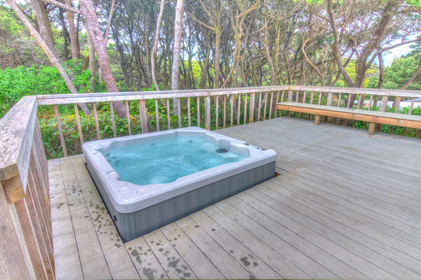 Enjoy the sunken hot tub on the deck surrounded by the shore pines.