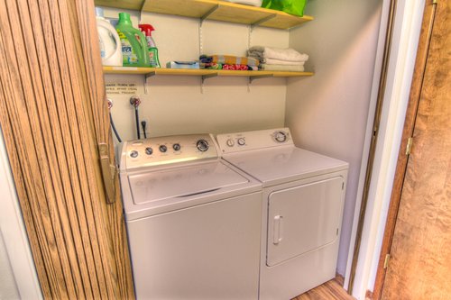 The washer and dryer are tucked in to the hallway bathroom for easy access.