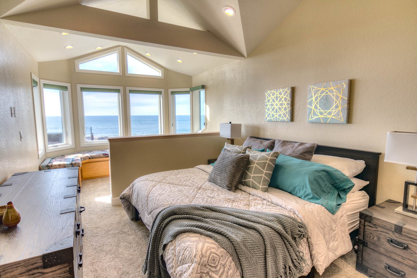 King bed in upstairs bedroom with a sitting area to enjoy the views.