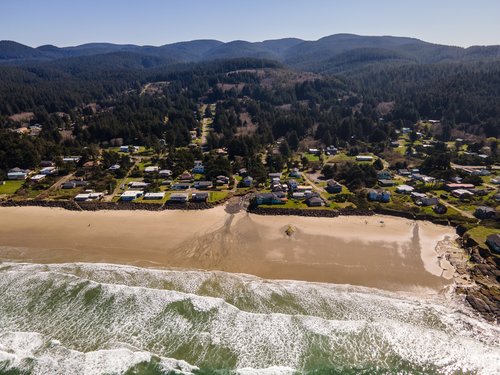 Miles of sandy beach to the north and some tidepool rocks to the south.