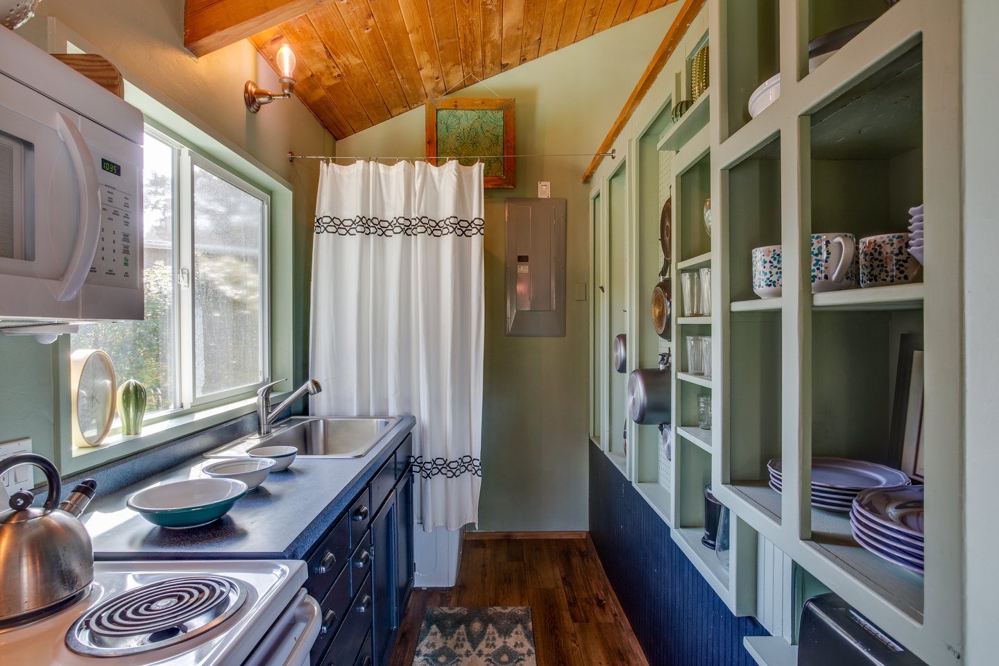 Washer and dryer are provided behind the curtain.