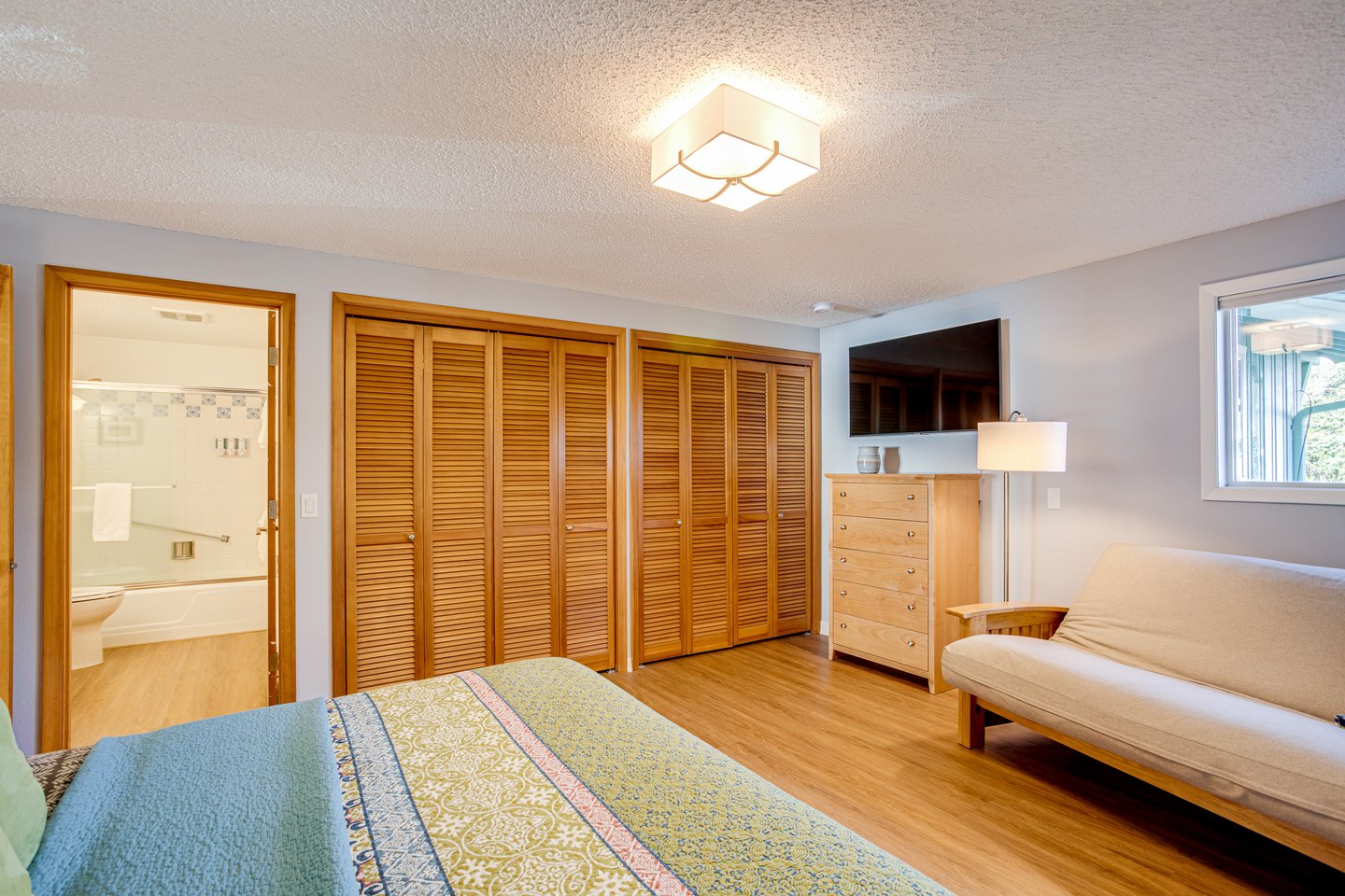 Master bedroom with an ensuite bath down the hall from the living room.