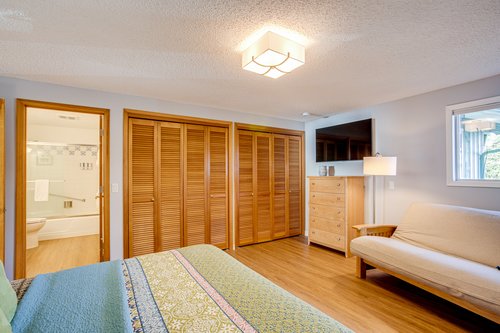 Master bedroom with an ensuite bath down the hall from the living room.