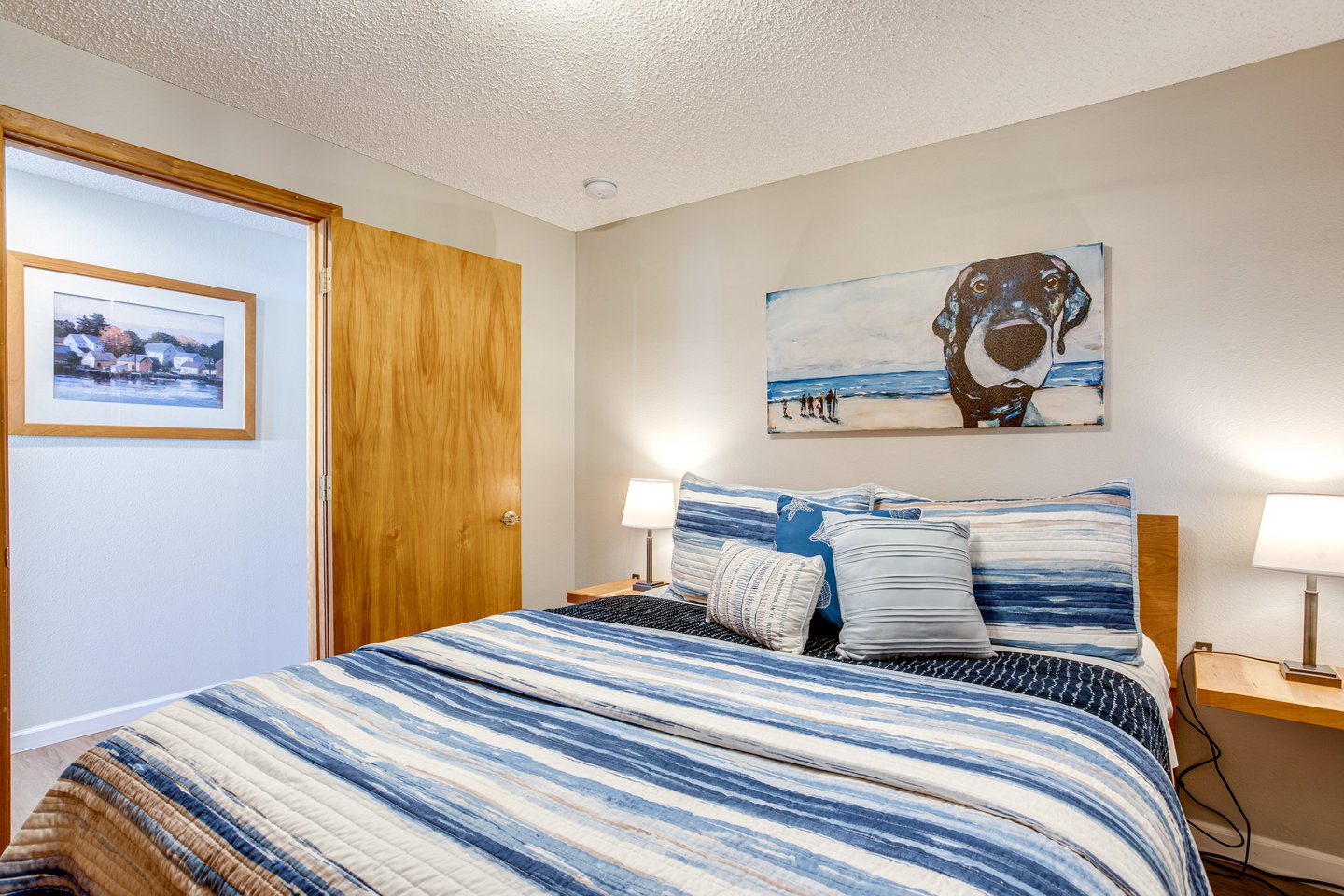 Second bedroom down the hall from the living room has a queen bed.