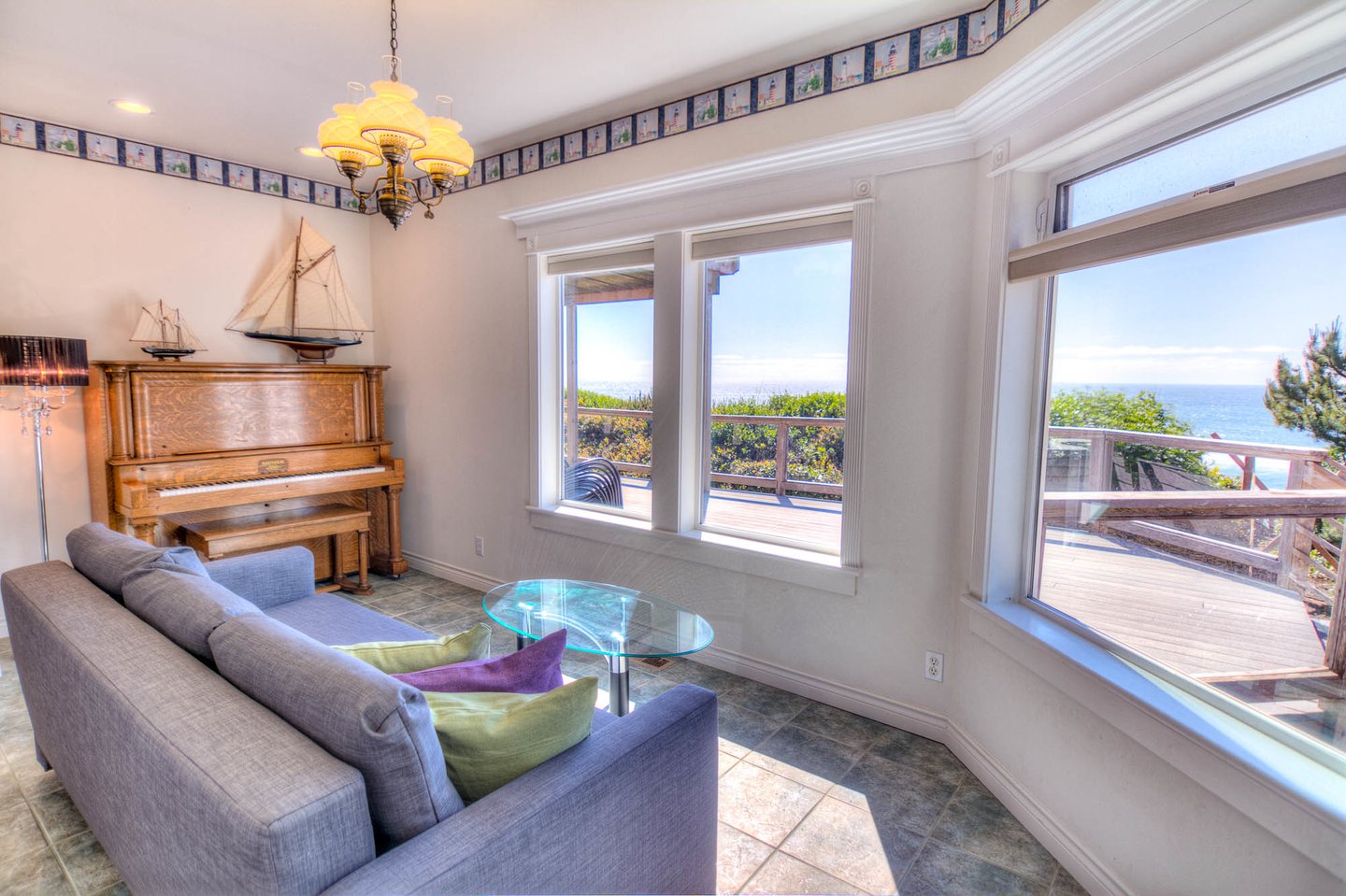 Sitting room with piano on the first floor with a futon for extra sleeping.