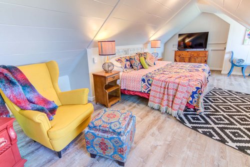 Under the eaves is this roomy bedroom with a king size bed that can be split in to twins.
