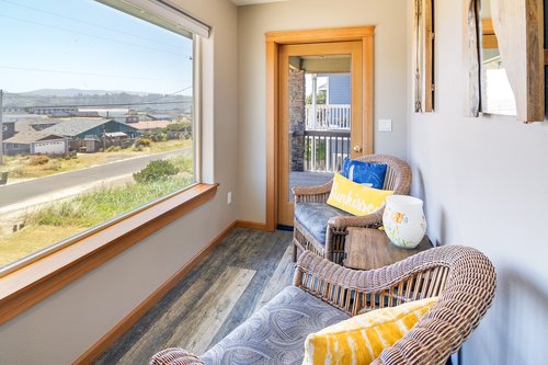 The sitting room off of the master bedroom is the perfect spot to watch the sun rise over the Alsea Bay.