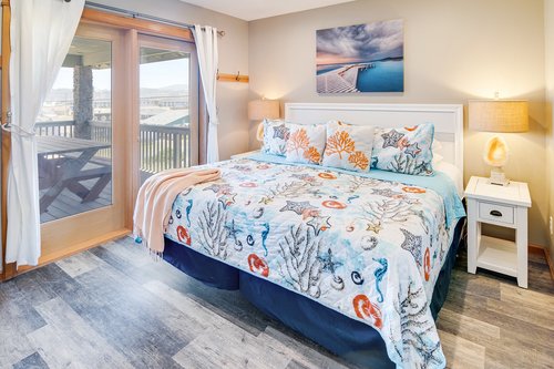 A cozy retreat, this upstairs king bedroom with access to the covered deck.